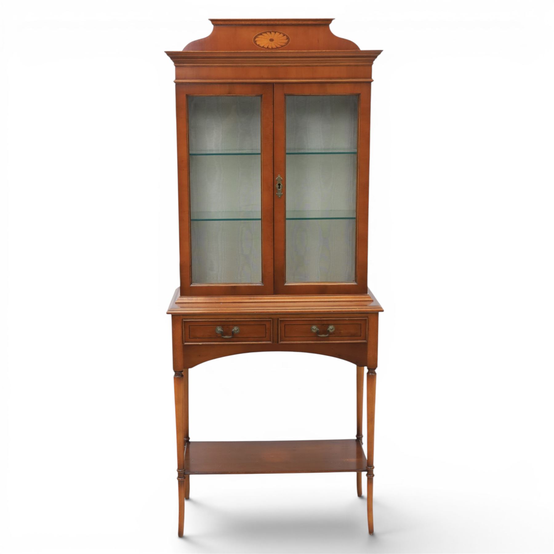 Sheraton design yew wood cabinet on stand, fitted with two glazed doors and two drawers, with lower shelf, illuminated interior