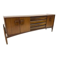 Elliots of Newbury (EoN) - mid-20th century teak sideboard, fitted with four central doors flanked by fall-front cupboard and a double cupboard, each with concave wooden handles