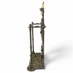 Early 20th century painted cast iron hall stand, formed as a standing armoured figure with red and yellow feathered crest, twin rails and integral drip tray with castellated edge