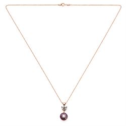 Gold and silver ruby and diamond pendant, single round brilliant cut diamond, surrounded by calibre cut rubies and round brilliant cut diamonds, suspending from a fancy pendant set with further diamonds, on a rose gold plated silver chain necklace, total diamond weight approx 0.30 carat, total ruby weight approx 0.30 carat