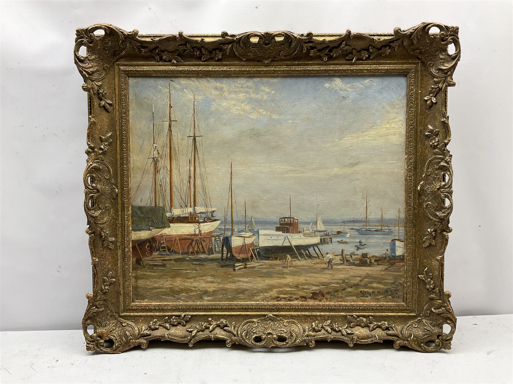 Alex H Kirk (British 1881-1950): Boat Maintenance on the Banks of an Estuary, oil on canvas signed and dated 1937, 50cm x 60cm
