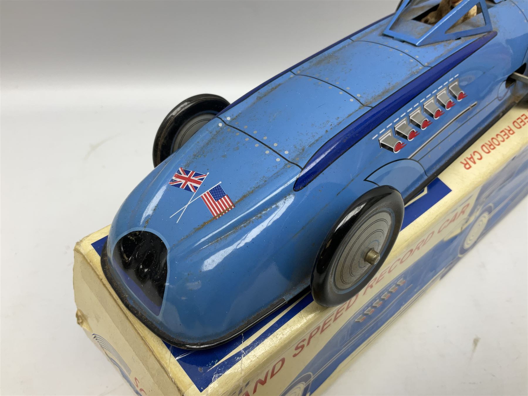 Schylling Collector Series clockwork tin-plate Sir Ian's Bluebird Land Speed Record Car with key and paperwork No.006080; boxed; and clockwork silvered tin-plate model of an 0-6-0 locomotive; unboxed (2)