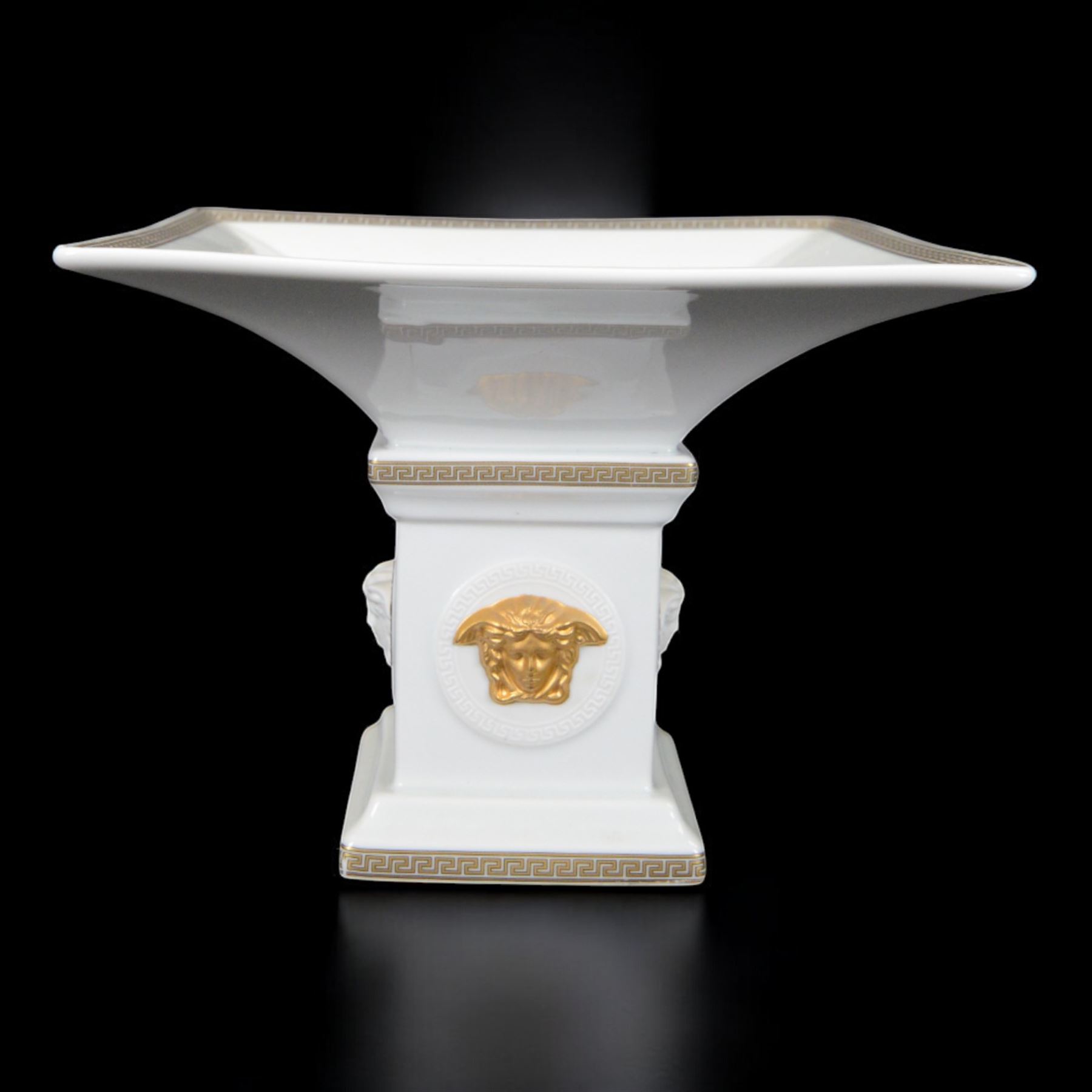 Rosenthal Versace Gorgona pedestal dish, of square form, decorated in relief with Medusa masks and with gilt Greek key borders to the rim and base, boxed, H15cm