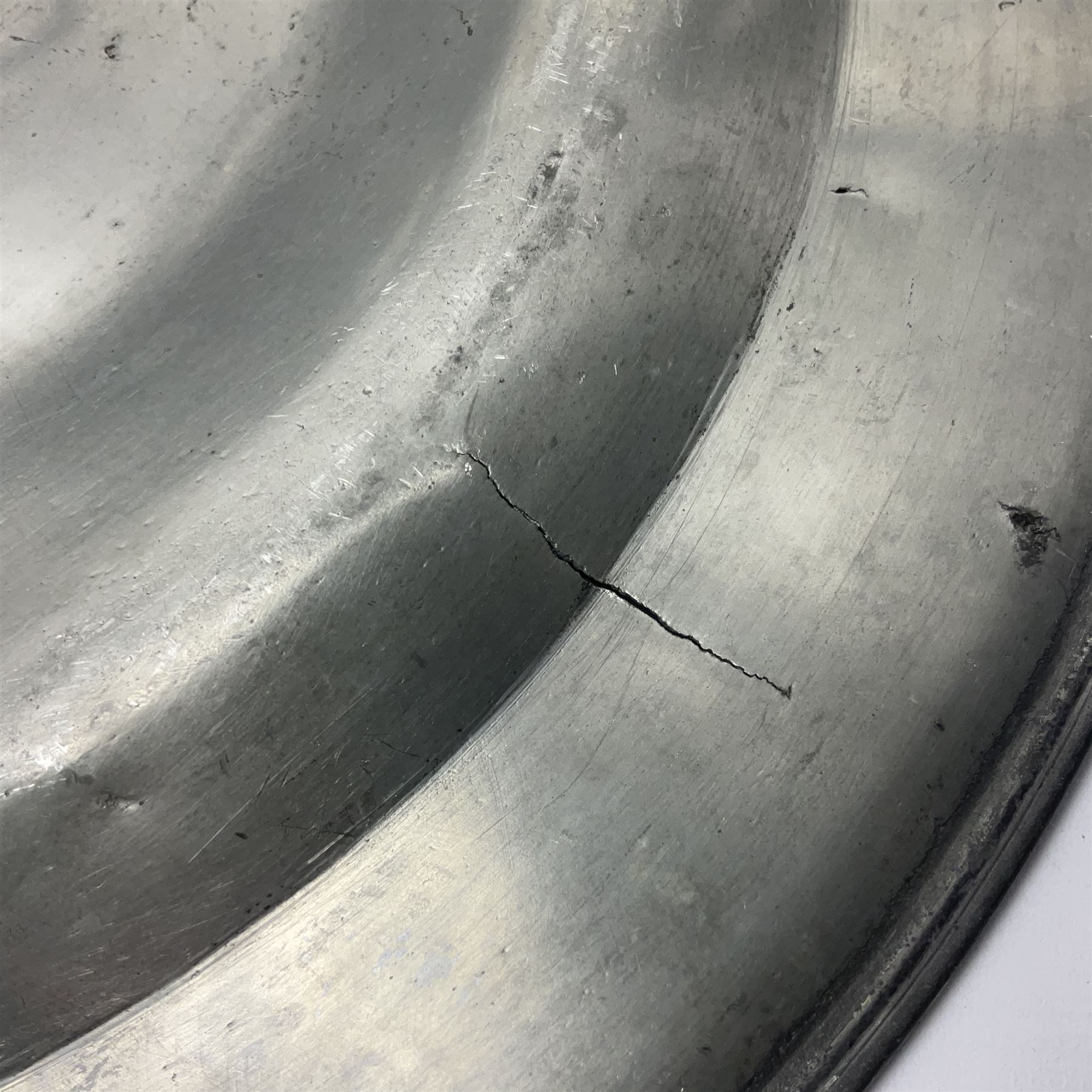 Group of seven 19th century pewter chargers, each of circular form with dished centre, two examples with touch marks verso, each approximately D39cm