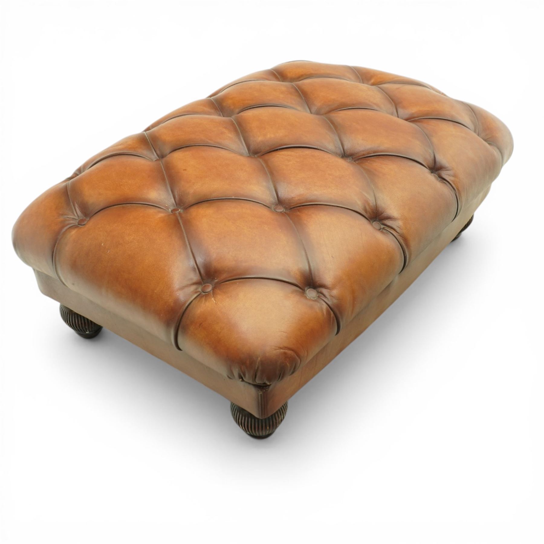 Tetrad England - large armchair upholstered in buttoned leather, with stool