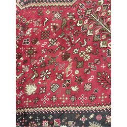 Persian Hamadan rug, red ground lozenge on dark field, decorated all-over with small animal and bird motifs, repeating guarded border