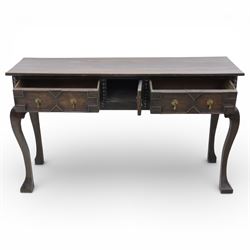 Late 19th century Jacobean revival oak side table, plank top with moulded edge over a central cupboard door and two frieze drawers carved with geometric lozenge motifs and framed by bobbin turned uprights, fitted with brass drop handles, raised on shaped cabriole supports with block feet