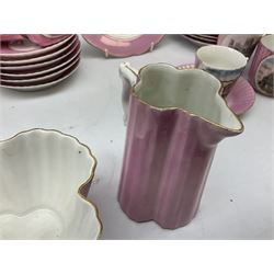 Group of 19th Century pink lustre souvenir wares, to include set of six Wright & Archibald Drapery Establishment teacups and saucers, together with jug, quatrefoil bowl and pierced edge plates, all stamped Made in Germany beneath, York Minster beaker and Clifton Suspension Bridge cup and saucer