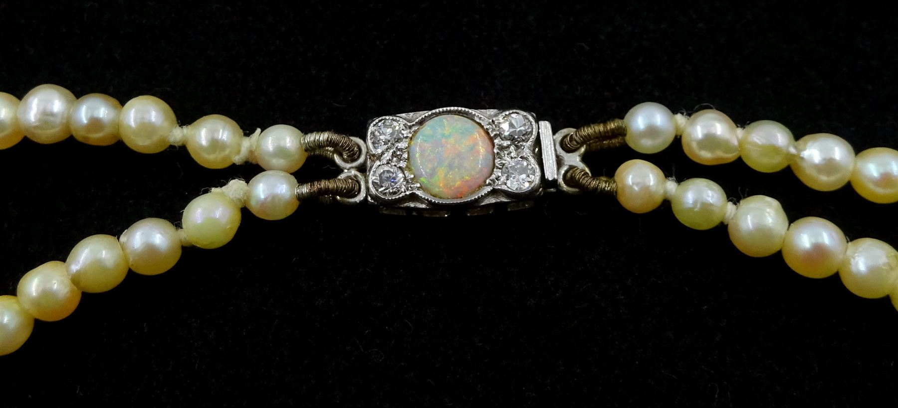 Double strand pearl necklace, graduating pearls between 3mm and 7.5mm, on 18ct white gold old cut diamond and opal milgrain set clasp, boxed