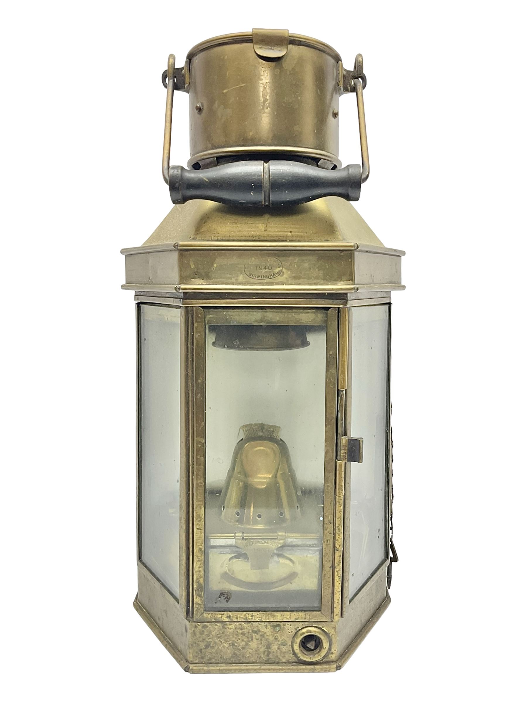 Large brass maritime lamp by Griffiths & Sons Birmingham with swing handle, threaded mounting bracket and associated oil burner, H41cm excluding handle