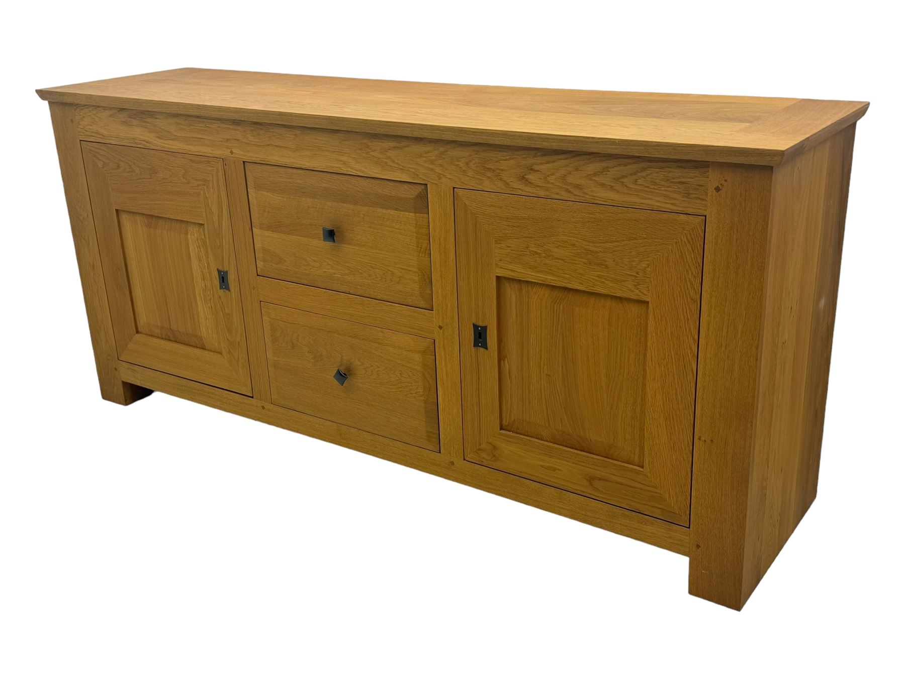 Contemporary light oak sideboard, chamfered rectangular top over two central bevel-edged drawers, flanked by two recessed panelled cupboards enclosing shelving, on square stile supports