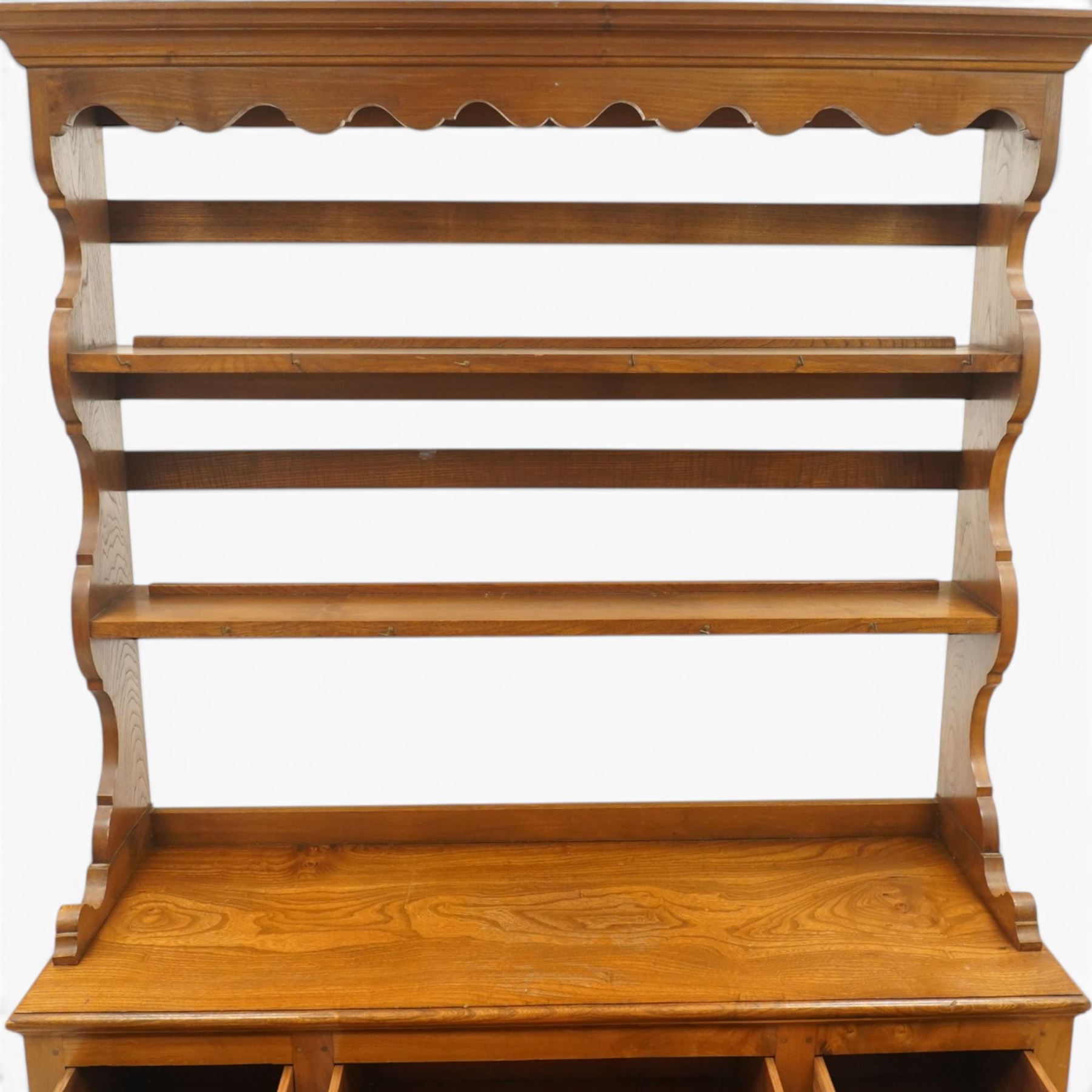 Georgian design elm dresser with plate rack, the two-tier rack with shaped frieze and hooks, over a rectangular top, fitted with three yew-wood banded drawers, shaped apron over turned supports united by undertier
