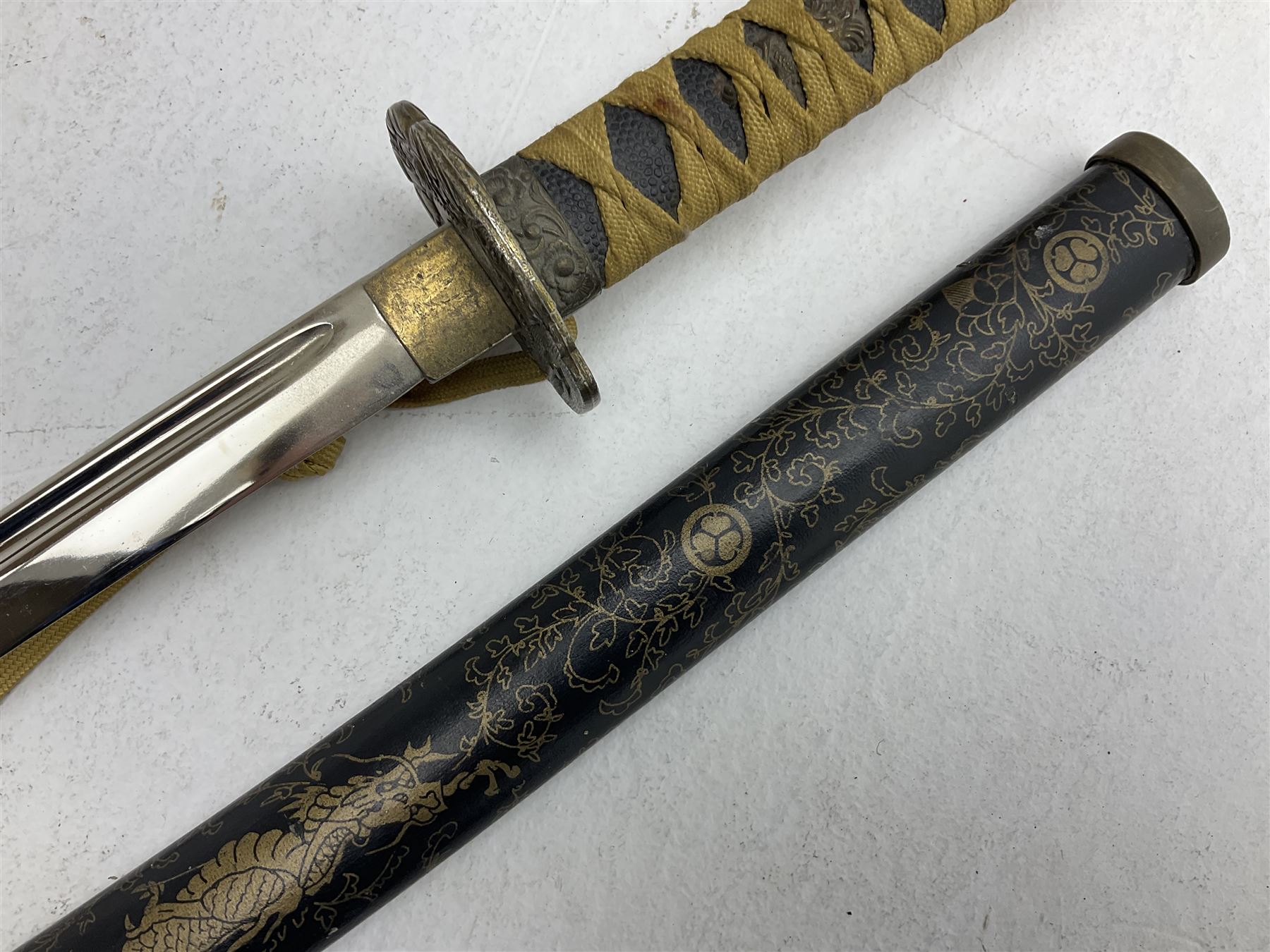 Reproduction Japanese katana with 63cm slightly curving fullered steel blade, ornate tsuba, cord bound grip and gilt transferred black saya L92cm; and two fencing foils, one marked Leon Paul (3)