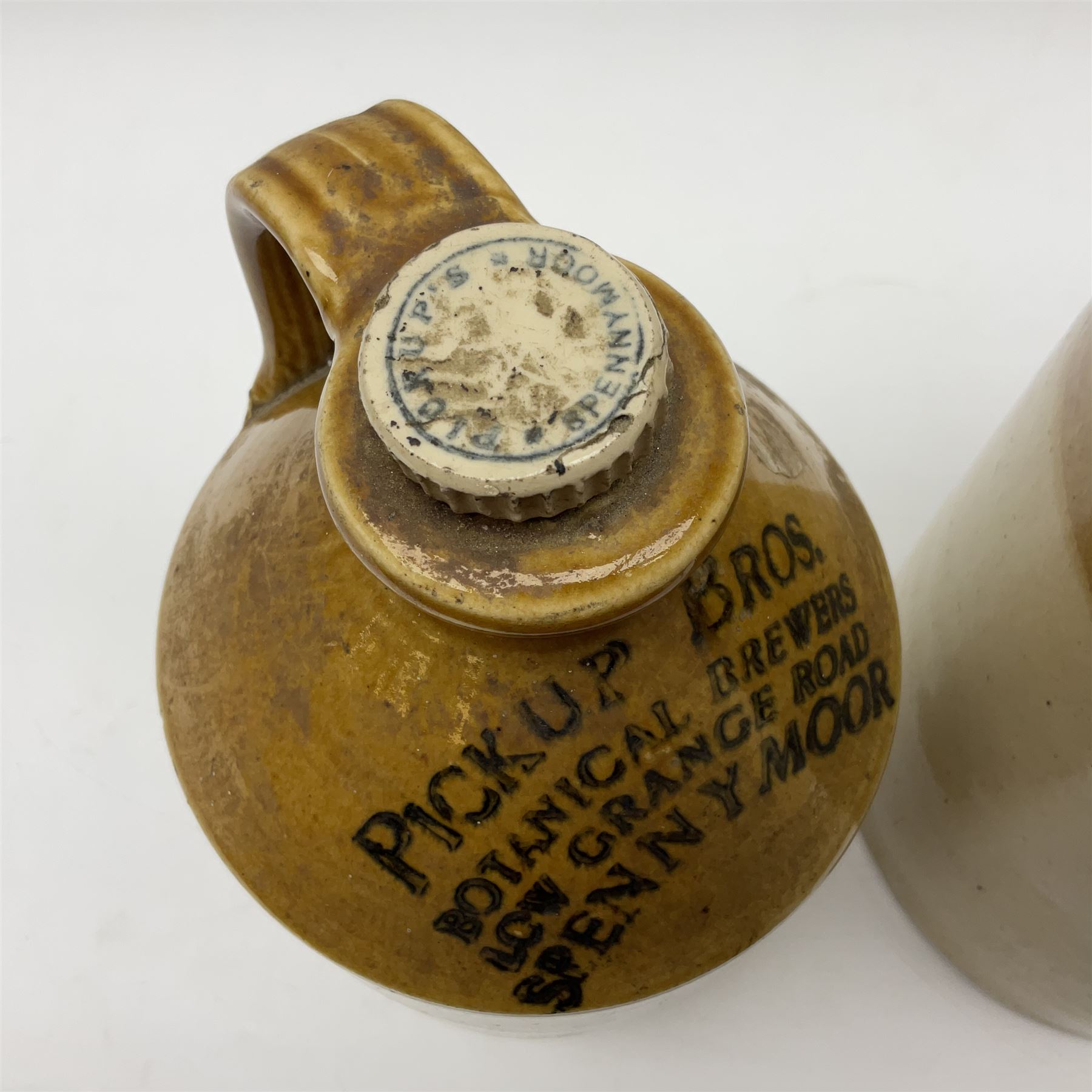Early 20th century stoneware advertising flagon, marked to front 'Pickup Bros Botanical Brewers', together with a larger stoneware flagon