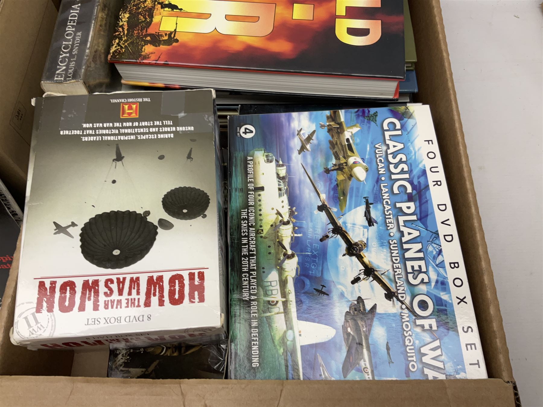 Three boxes of books, periodicals and DVDs of military interest with particular emphasis on WW2 including The History of World War Two in thirty original parts by Orbis, The D-Day Experience by Richard Holmes, The World War Two Databook, The World at War, Special Forces etc