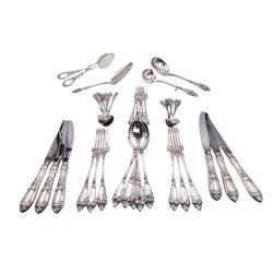 1930s Norwegian silver cutlery for six place settings, comprising table spoons, table forks and silver handled table knives, cake forks, tea spoons and demitasse spoons, one cake slice, serving spoon, sauce ladle and a pair of silver handled servers, all embossed with rose decoration and engraved with initial K to terminal and 10/9 1932 verso, stamped NM 830s