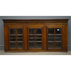  Early 20th century mahogany wall hanging cabinet, projecting cornice, three glazed doors, single shelf, W142cm, H71cm, D23cm  