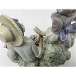 Lladro figure group For You, 5453, modeled as a woman with parasol taking a flower off a kneeling man, H25cm 