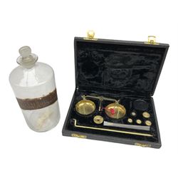 19th century clear glass apothecary jar with label, together with a cased set of balance scales and weights, in one box 