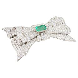 Platinum emerald and diamond bow brooch, central octagonal cut emerald of approx 4.00 carat, with round brilliant and baguette cut diamond surround, total diamond weight approx 23.00 carat