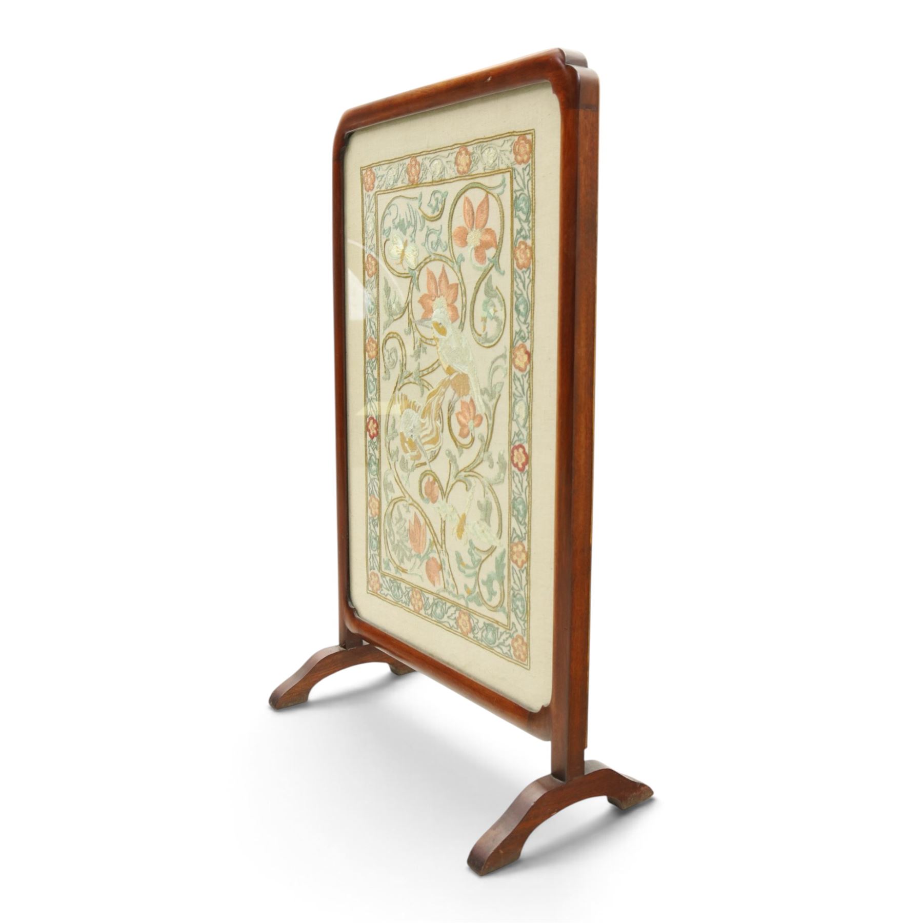Victorian mahogany firescreen, rounded rectangular frame inset with embroidered panel depicting exotic birds amongst scrolling flowering foliage and butterflies, on out-splayed feet