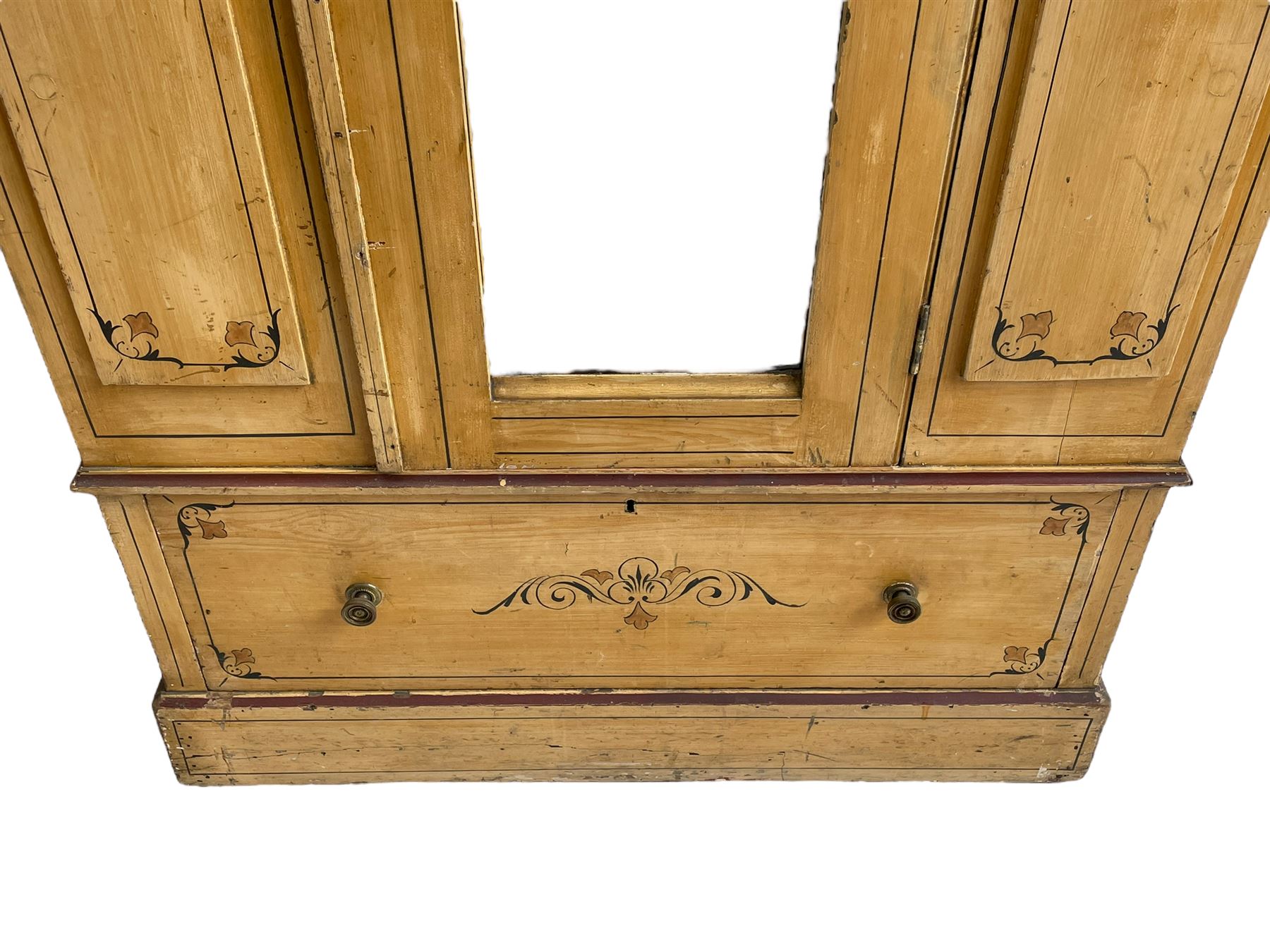 19th century painted pine wardrobe, the projecting cornice over mirror glazed door, with painted decoration depicting scrolling foliate and urns, drawer to base on skirt