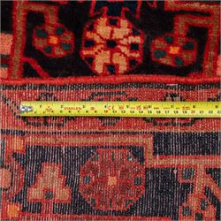North West Persian runner, the indigo field centred by a red elongated hexagonal medallion with pendant motifs, surrounded by angular flowering stems, ivory stepped floral spandrels, enclosed by an indigo palmette border and red floral guard bands