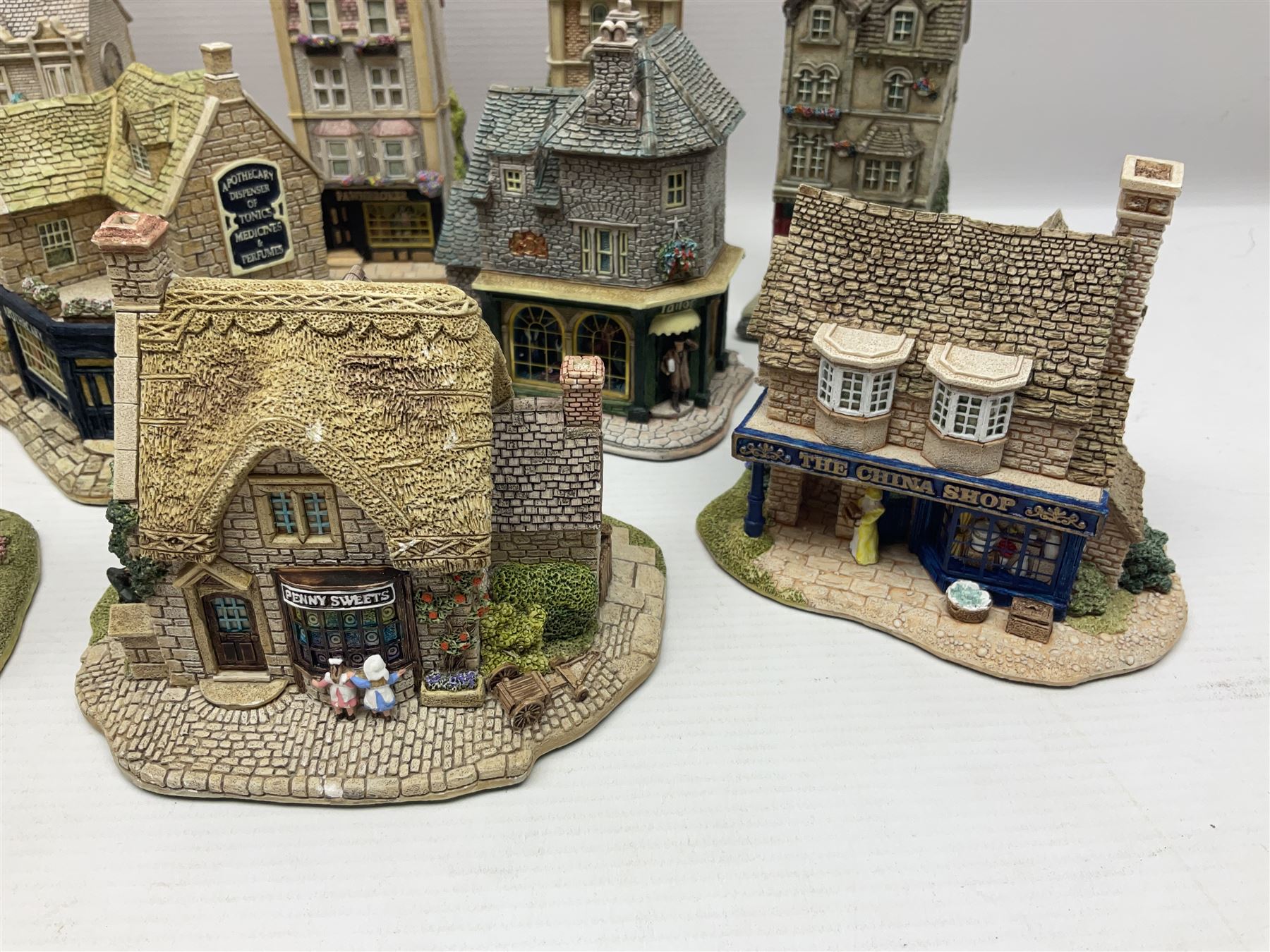 Thirteen Lilliput Lanes from the Shops Collection, including Apothecary, Horologist, China Shop, Penny Sweets, H Samuel etc, all with deeds and original boxes 