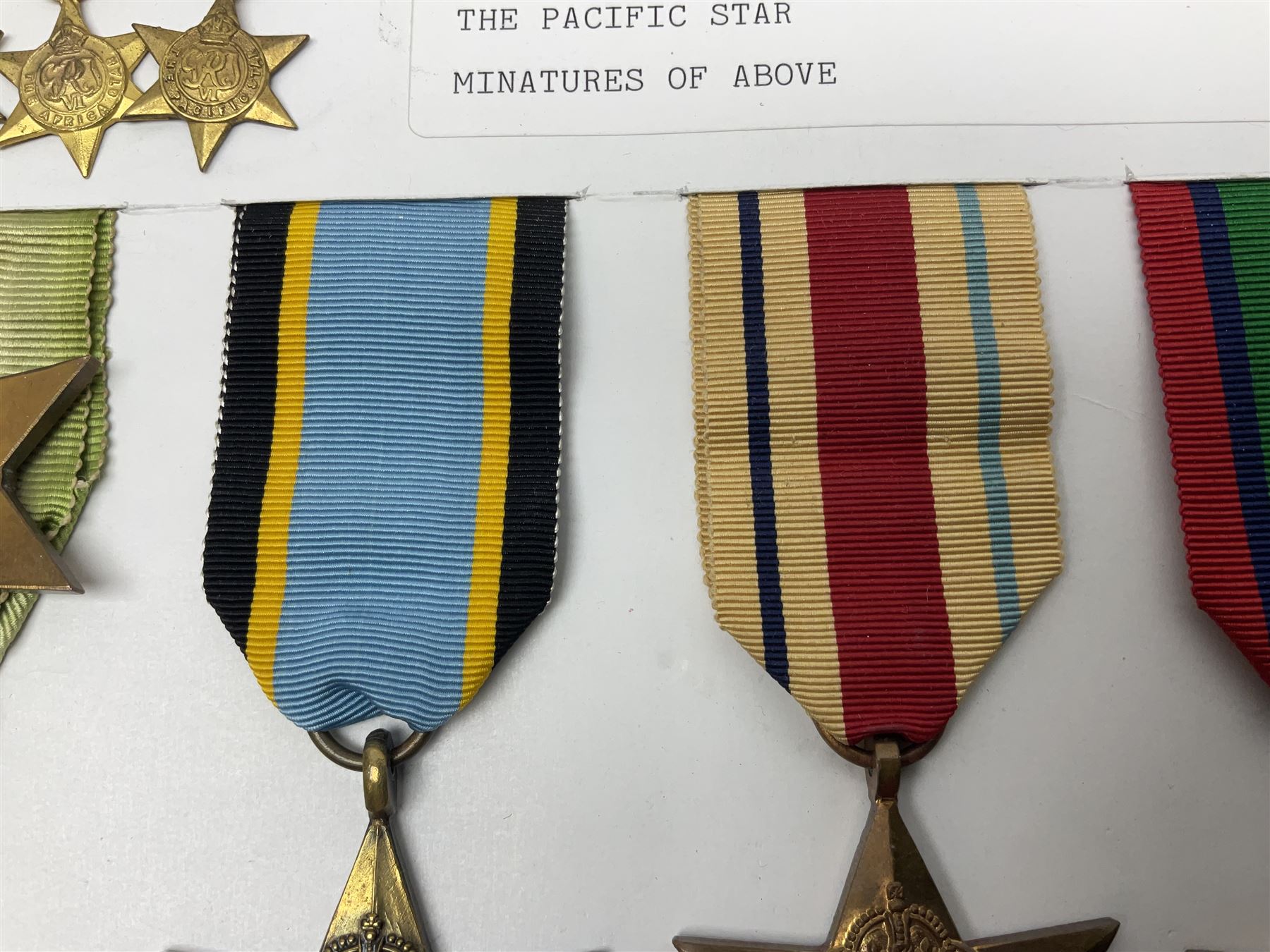 Representative display of WWII Campaign stars comprising 1939-1945 Star, Atlantic Star, Air-Crew Europe Star, Africa Star and Pacific Star; together with the corresponding group of miniatures; all with ribbons