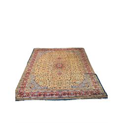 Large Amritsar camel ground carpet, central floral medallion within an interlocking foliate field, five band border, the main band decorated with repeating stylised flower head motifs