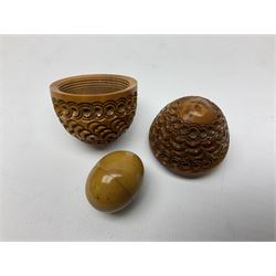 Three 19th century coquilla nut pomanders or flea catchers, each of egg shaped form with carved and pierced decoration and screw threaded join, largest example 6cm