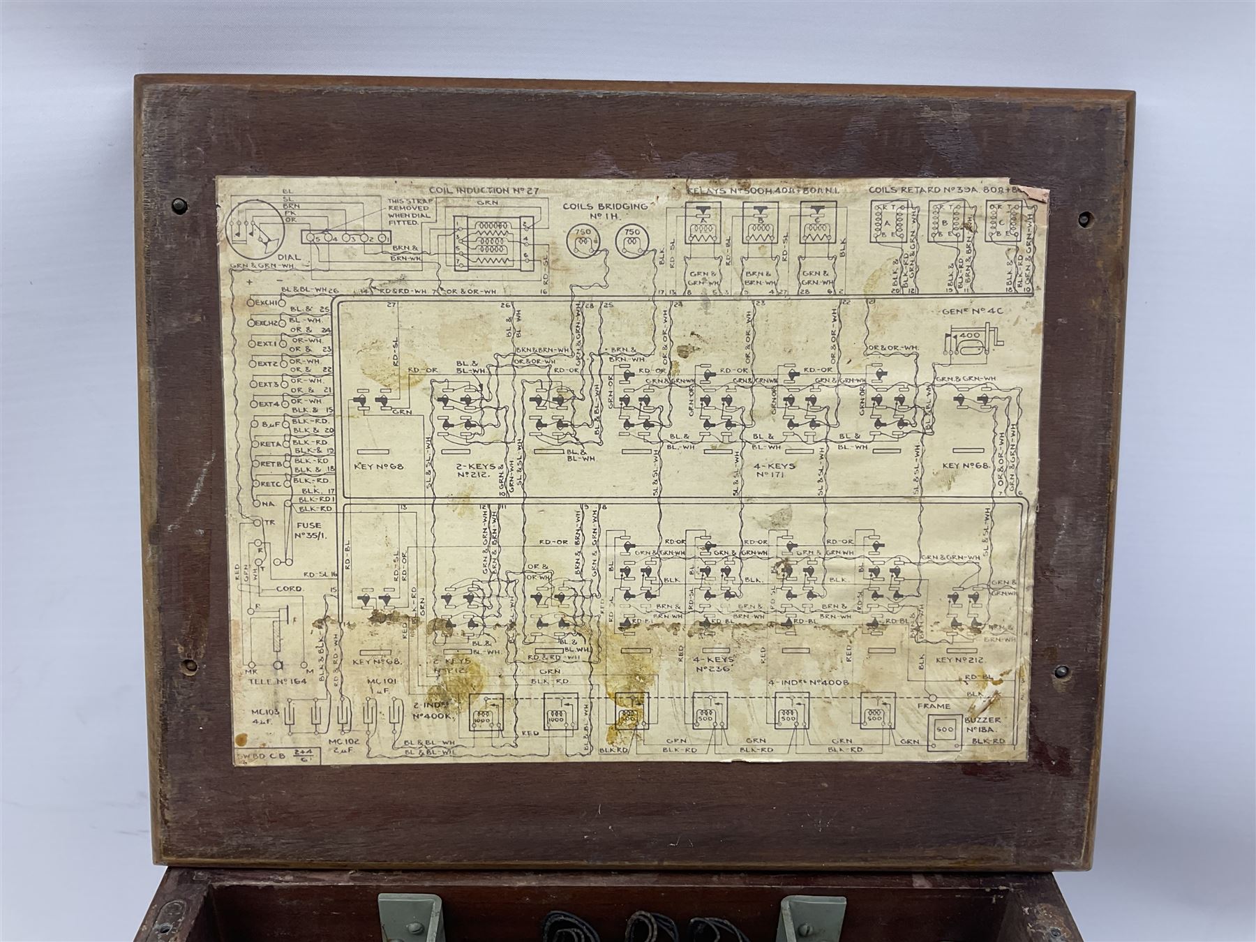 Early-mid 20th century internal telephone system, comprising exchange box with attached TMC rotary telephone and dictograph with Bakelite handset and support upon stained wood case, and 1960s black Bakelite telephone model 312L with G.P.O sticker beneath, largest H30.5cm W36.5cm D30cm