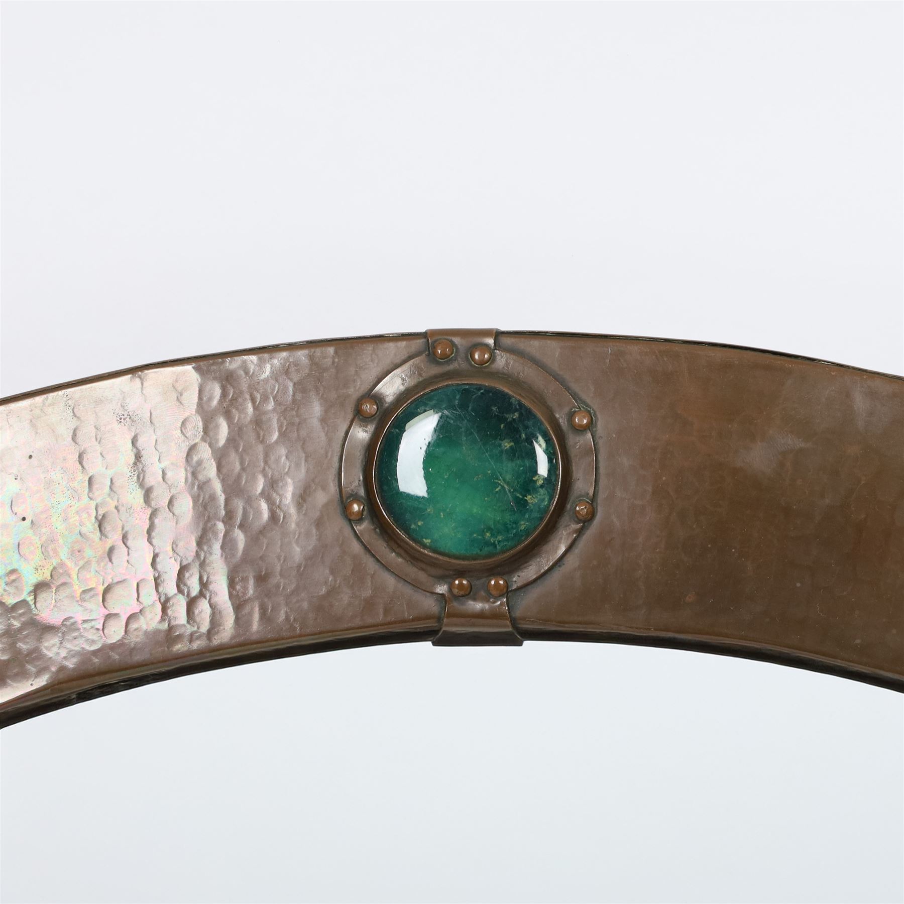 Liberty & Co, Arts and Crafts hammered copper framed oval wall mirror, mounted by four turquoise Ruskin cabochon roundels, with ivorine maker's label verso