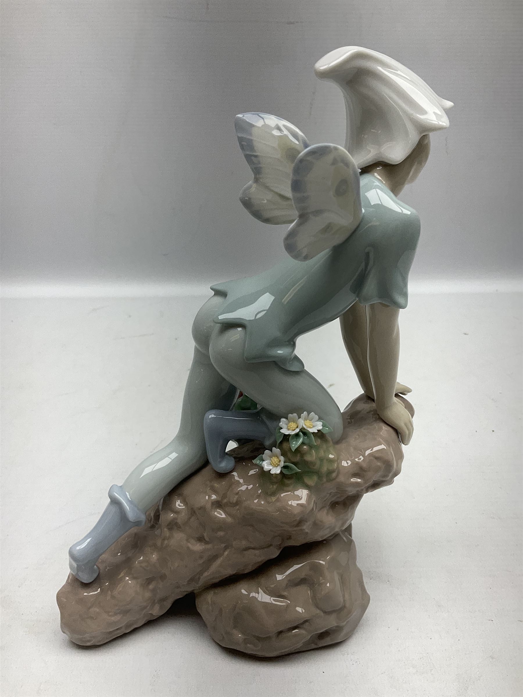 Lladro Privilege figure, Prince of Elves, modelled as an elf with wings leaning upon a rock, with original box, no 7690, sculpted by Joan Coderch, year issue 2001, year retired 2003, H23cm