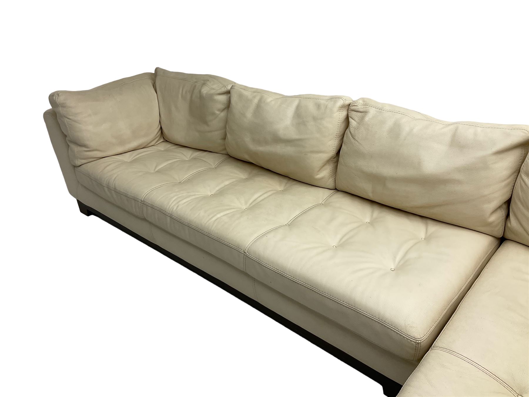Roche-Bobois - large corner sofa, upholstered in ivory leather with buttoned seat cushions, raised on a stained beech base with bracket feet
