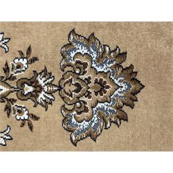 Persian design golden beige ground rug, the field with symmetrical scrolling foliate and floral designs, central floral medallion, bordered by a multi-layered band with floral and vine patterns in contrasting beige and dark brown tones