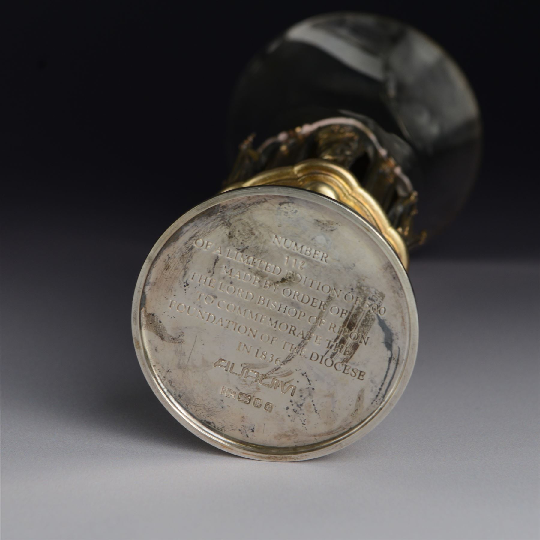 Modern limited edition silver goblet, 'made by order of the Lord Bishop of Ripon to commemorate the foundation of the Diocese in 1836', designed by Hector Miller for Aurum, the plain fluted cup, upon an ornate figural parcel gilt stem and stepped circular foot, no. 112/500, hallmarked Hector Miller, London 1985, H17cm, with certificate