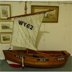  Good 20th century hand built scale model of a Whitby Coble, traditionally constructed with copper rivited larch on oak with brass plaque 'Built by A. Russell, Whitby, Yorks' complete with mast, sail, rudder & tiller, oars, ropes and tackle, painted numbers WY62, SF37 & WHITBY, L216cm, H203cm, W63cm  