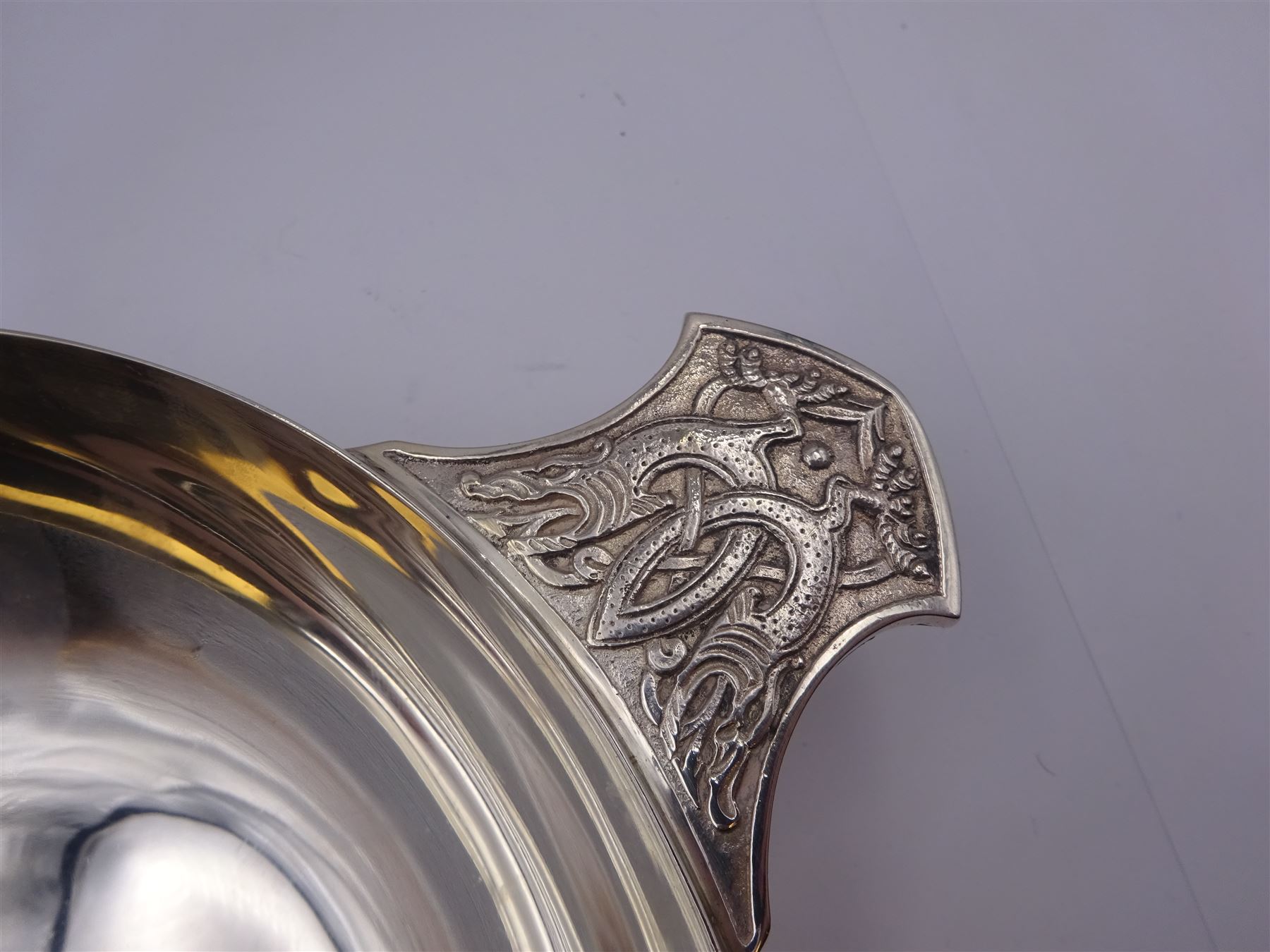 Large modern silver Quaich, of circular form with twin handles cast with stylised dragon motifs, hallmarked Birmingham 2009, makers mark W&W, D18cm, approximate weight 11.14 ozt (346.8 grams)