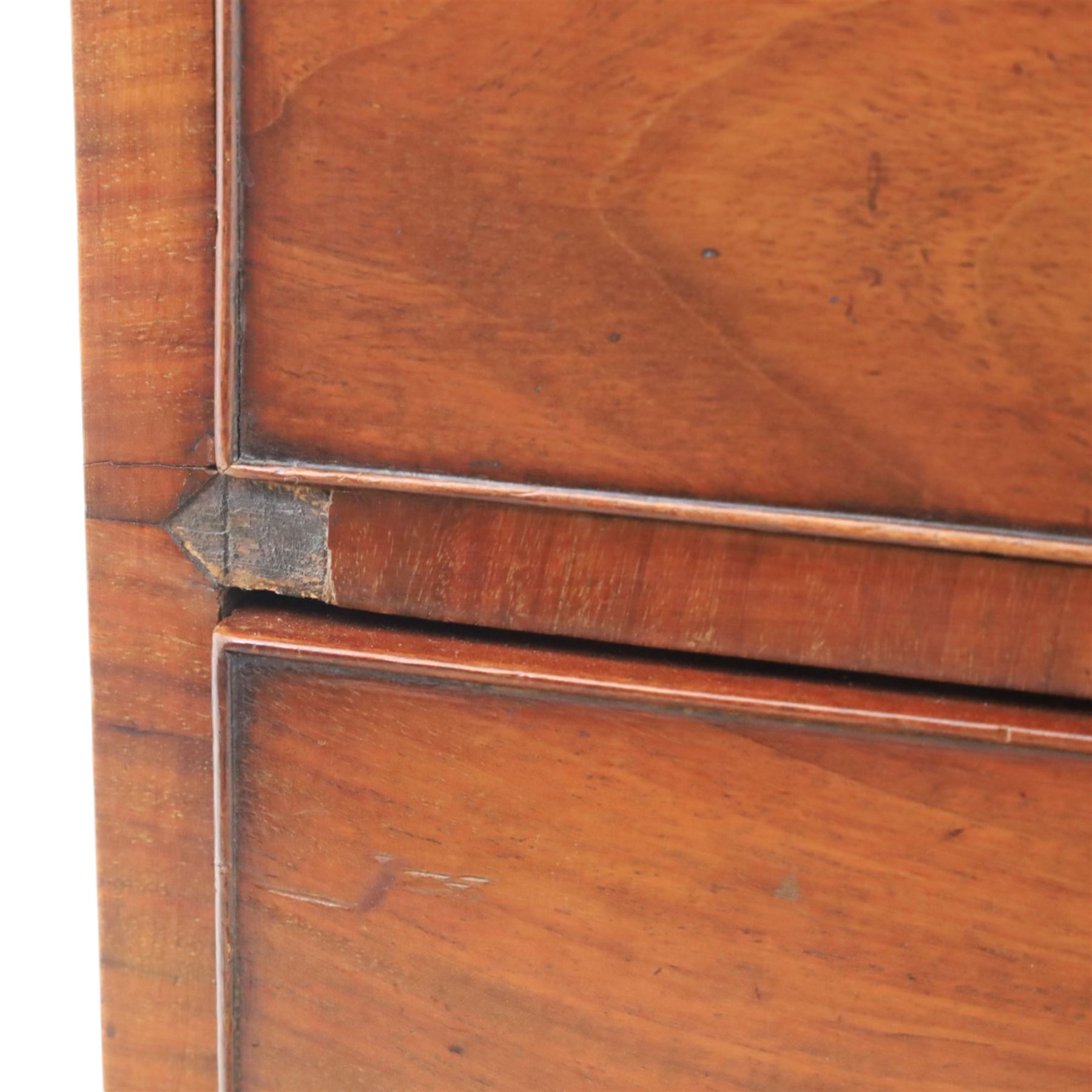 Early 19th century mahogany chest, fitted with short and two long drawers, crossbanded top, raised on bracket feet