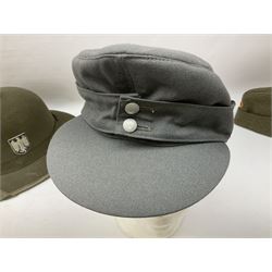 Five reproduction German WW2 hats comprising Wehrmacht olive tropical helmet, Heer officer's peaked cap, two M43 caps and Field side cap (5)