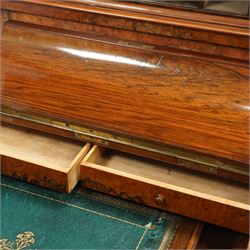 Victorian figured walnut piano top Davenport desk, hidden compartment lifting to reveal small drawers and pigeonholes, the piano lid enclosing drawers and sliding top with hinged leather writing surface, the right-hand side fitted with four drawers, on compressed bun feet 
