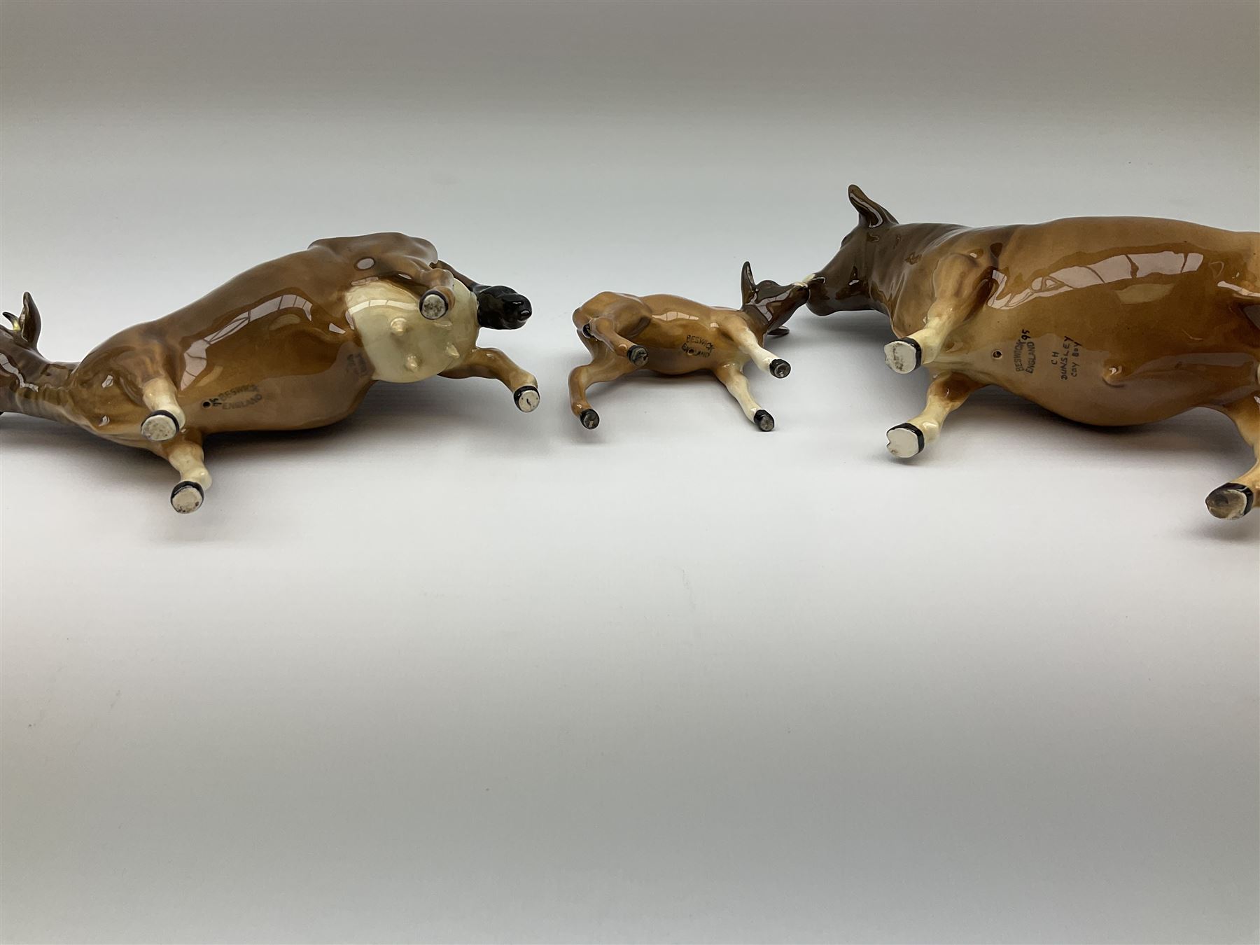 Beswick Jersey family group, comprising bull Dunsley Coy Boy model no 1422, cow Newton Tinkle model no 1345, and calf model no 1249d.