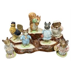 Seven Beswick Beatrix Potter figures, comprising Sally Henny Penny, Johnny Town-Mouse, Mrs Tiggy-Winkle, Mrs Tittlemouse, Tom Kitten, Pig-Wig and Squirrel Nutkin, together with a Beswick tree trunk display stand, stand L30cm