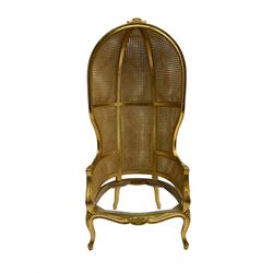 French style gilt wood and cane bergère porter's chair, the canopy top carved with flowers, barrelled back with double cane work, on cabriole supports