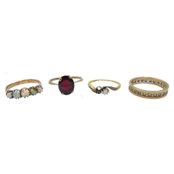 18ct gold diamond ring, gold garnet ring, gold opal ring and a stone set eternity ring, all 9ct stamped or tested