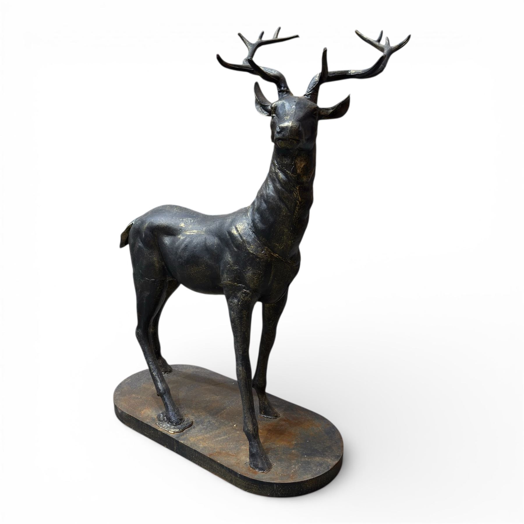 Pair of life-size cast iron garden or home stags, modelled standing upon oval plinths