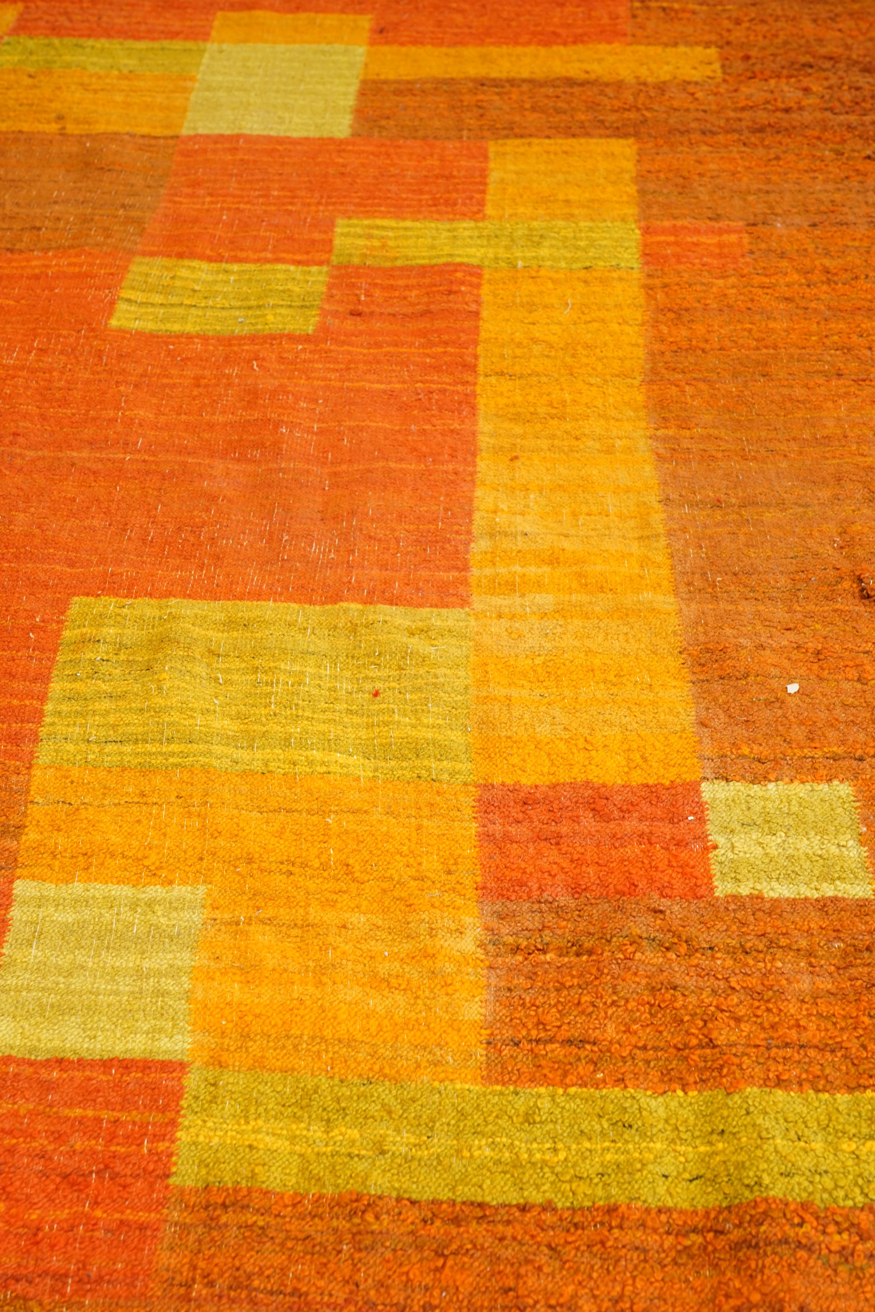 Vintage handwoven modernist rug with cubist design in contrasting tones of amber and orange