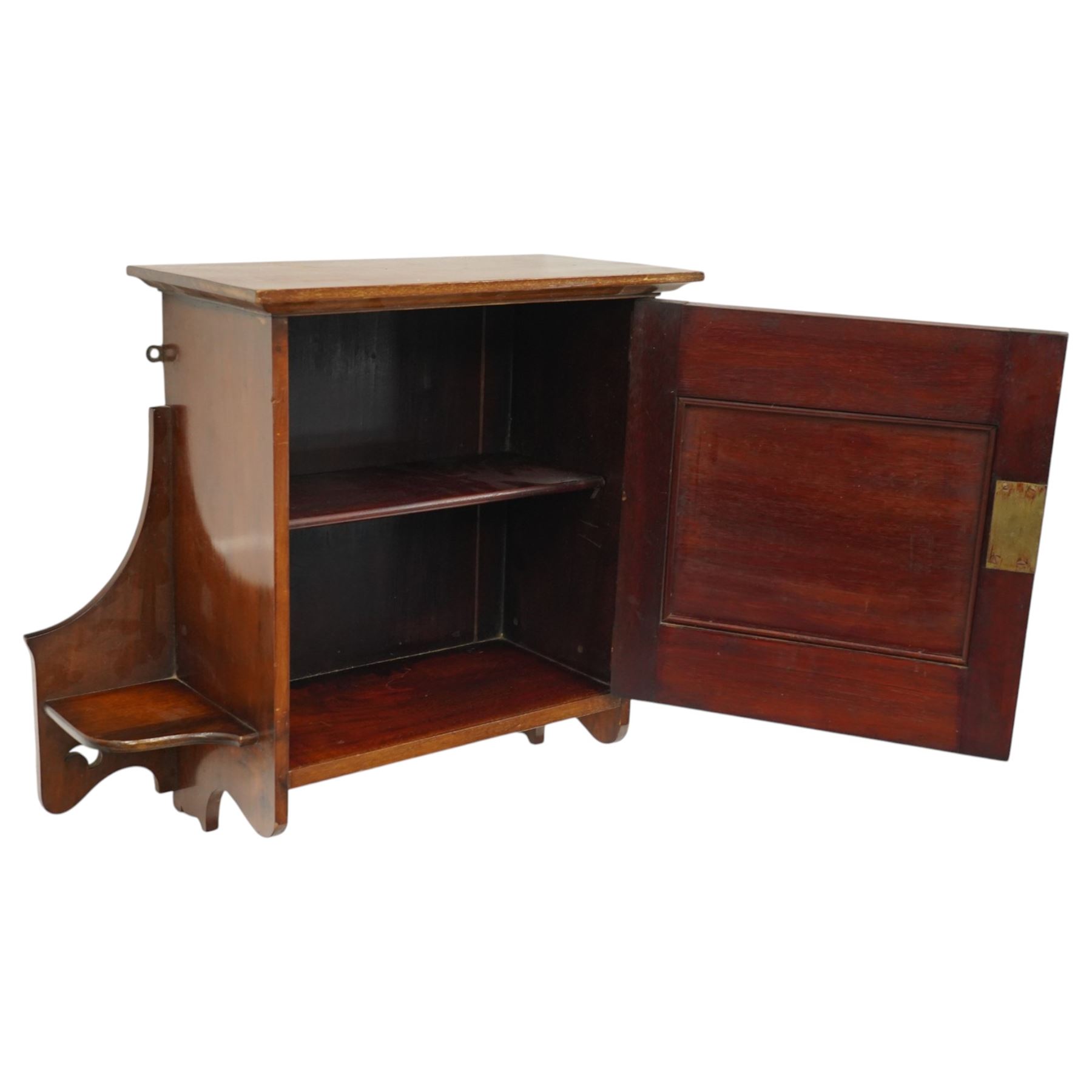 Small Arts & Crafts mahogany wall cupboard, single panelled door enclosing shelf, flanked by two shelves with pierced brackets, with shaped copper fittings and escutcheon 