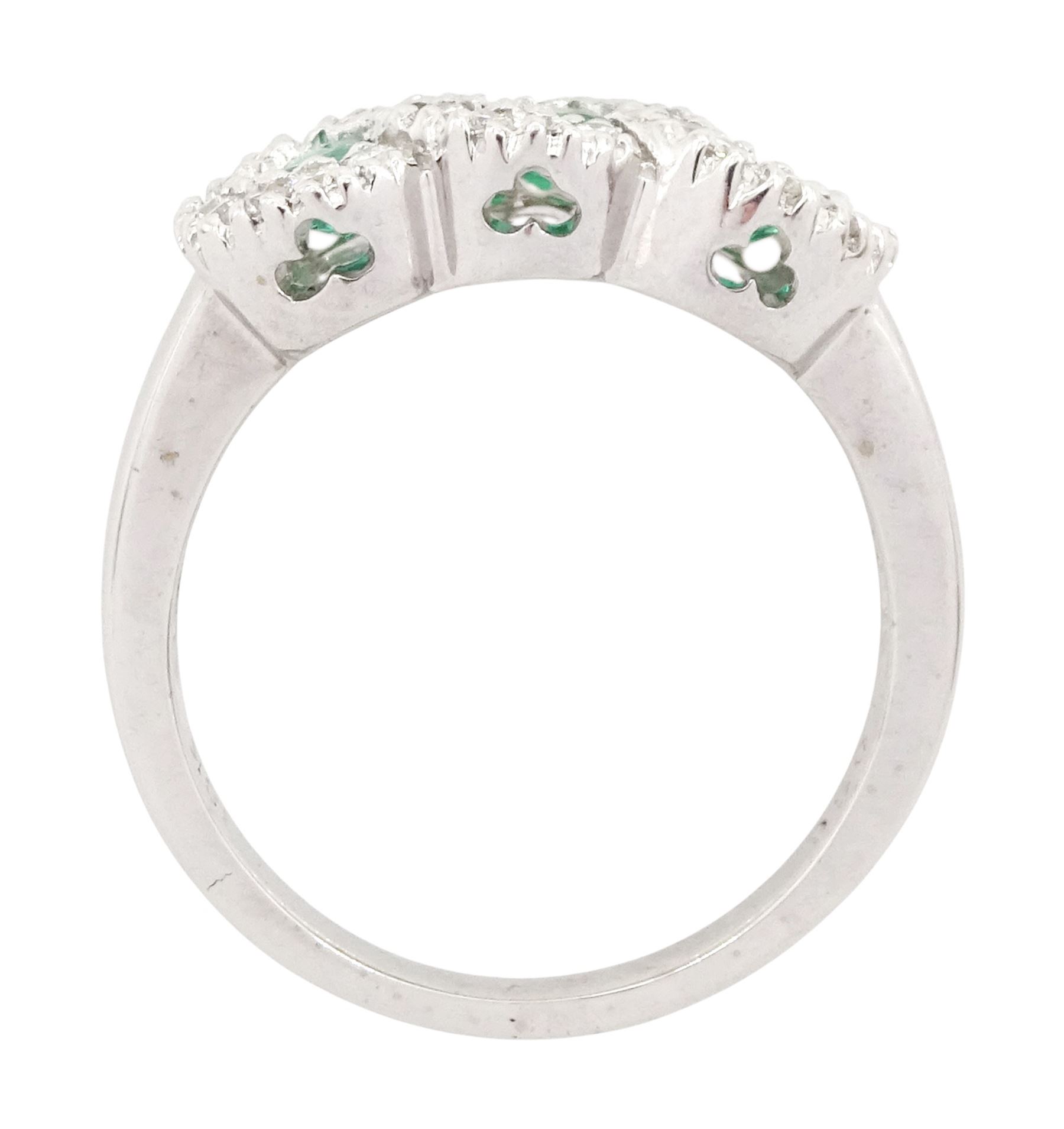 18ct white gold emerald and diamond triple cluster ring, three round cut emeralds, surrounded by round brilliant cut diamonds, the gallery with pierced trefoil motifs, stamped, total emerald weight approx 0.30 carat, total diamond weight approx 0.30 carat